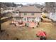 Wide aerial view showcasing a sprawling backyard with a patio, a cozy seating area, and mature trees at 1219 Hadaway Ct, Lawrenceville, GA 30043