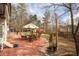 Backyard with a brick patio, outdoor seating, and a grass area at 1219 Hadaway Ct, Lawrenceville, GA 30043