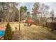 Large grassy backyard features mature trees and a firepit seating area, creating an inviting outdoor space at 1219 Hadaway Ct, Lawrenceville, GA 30043