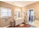 Bathroom featuring double sinks, wood-look floors, and a separate water closet at 1219 Hadaway Ct, Lawrenceville, GA 30043