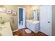 Bathroom with double sinks, white cabinets, and tile floors, with a separate water closet at 1219 Hadaway Ct, Lawrenceville, GA 30043