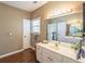 Bright bathroom featuring a double sink vanity, plenty of lighting, and wood-look floors at 1219 Hadaway Ct, Lawrenceville, GA 30043