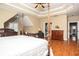 An expansive main bedroom with a four-poster bed and adjoining sitting area at 1219 Hadaway Ct, Lawrenceville, GA 30043