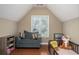Cozy bedroom featuring a comfortable armchair, window with blinds, mini fridge, and charming decor at 1219 Hadaway Ct, Lawrenceville, GA 30043