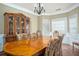 Elegant dining room featuring a large table, classic hutch, and natural light from windows at 1219 Hadaway Ct, Lawrenceville, GA 30043