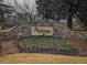 Stone sign for 'The Hadaway' community surrounded by colorful landscaping and a well-manicured lawn at 1219 Hadaway Ct, Lawrenceville, GA 30043
