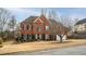 Charming red brick home with a spacious front yard and mature landscaping in a residential neighborhood at 1219 Hadaway Ct, Lawrenceville, GA 30043
