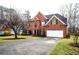 Two-story brick home with attached two-car garage and landscaped front yard at 1219 Hadaway Ct, Lawrenceville, GA 30043