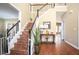 Inviting foyer with hardwood floors, a staircase with dark trim, and a view into other rooms at 1219 Hadaway Ct, Lawrenceville, GA 30043