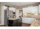 Well-lit kitchen boasts stainless steel refrigerator, granite countertops, and center island with dark wood accents at 1219 Hadaway Ct, Lawrenceville, GA 30043