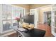 Well-lit office featuring a modern desk setup, a large window, and French doors leading to other rooms at 1219 Hadaway Ct, Lawrenceville, GA 30043
