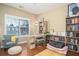 Bright home office featuring a window, desk, bookshelves, and a comfortable chair at 1219 Hadaway Ct, Lawrenceville, GA 30043