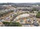 Scenic aerial view of homes nestled around a pond, surrounded by lush trees and hills at 15 Lakeside Way, Cartersville, GA 30121