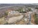 Scenic aerial view of a residential neighborhood featuring a pond, homes, and surrounding wooded landscape at 15 Lakeside Way, Cartersville, GA 30121