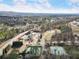 An aerial view showcases a community with a pool, tennis courts, and scenic landscape at 15 Lakeside Way, Cartersville, GA 30121