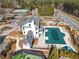 Aerial view of a community with a pool, tennis courts, and meticulously landscaped grounds surrounding a white clubhouse at 15 Lakeside Way, Cartersville, GA 30121