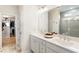 Bright bathroom with double vanity, large mirror, tiled floors, and walk-in closet access at 15 Lakeside Way, Cartersville, GA 30121