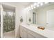 Bathroom with a large mirror, extended vanity, and a shower with decorative curtain at 15 Lakeside Way, Cartersville, GA 30121