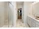 Bright bathroom showcasing a glass-enclosed shower, double vanity, and walk-in closet access at 15 Lakeside Way, Cartersville, GA 30121