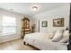 Bright bedroom featuring a four-poster bed, light wood floors, and an elegant antique armoire at 15 Lakeside Way, Cartersville, GA 30121