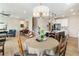 Open-concept dining area featuring modern lighting, wood floors and seamless access to the kitchen at 15 Lakeside Way, Cartersville, GA 30121