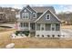 Charming gray two-story home featuring a welcoming front porch and beautiful landscaping at 15 Lakeside Way, Cartersville, GA 30121