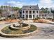Exterior view of a grand circular fountain and manicured landscaping in front of a distinguished white building at 15 Lakeside Way, Cartersville, GA 30121