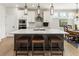 Modern kitchen with an island, stainless appliances, pendant lighting, and an adjacent dining area at 15 Lakeside Way, Cartersville, GA 30121