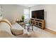 Comfortable loft area featuring hardwood floors, a sofa, a media center, and bright natural light at 15 Lakeside Way, Cartersville, GA 30121