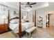 Spacious main bedroom featuring a four-poster bed, tray ceilings, and a neutral color palette at 15 Lakeside Way, Cartersville, GA 30121