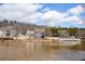 Two-story home and community seen across a pond with walking bridge at 15 Lakeside Way, Cartersville, GA 30121