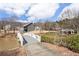 Back of two-story home seen from a small bridge over the pond, with greenery at 15 Lakeside Way, Cartersville, GA 30121