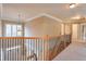 Hallway showcasing staircase, beautiful railing and natural light at 1380 Magnolia Park Cir, Cumming, GA 30040