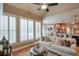 Bright living room boasts a high ceiling, hardwood floors, and large windows with plantation shutters at 1380 Magnolia Park Cir, Cumming, GA 30040