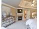 Stylish bedroom featuring a fireplace, ceiling fan and mirrored dresser at 1380 Magnolia Park Cir, Cumming, GA 30040