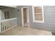 View of the covered outdoor porch with gray siding and white railing at 200 Ridge Bluff Ln, Suwanee, GA 30024
