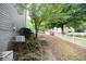 Landscaped backyard with steps leading to a fenced upper yard and lush greenery at 200 Ridge Bluff Ln, Suwanee, GA 30024