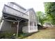 View of the home's exterior with a large deck and stairs leading to the landscaped backyard at 200 Ridge Bluff Ln, Suwanee, GA 30024