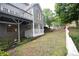 View of the home's exterior with a large deck and stairs leading to the landscaped backyard at 200 Ridge Bluff Ln, Suwanee, GA 30024