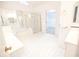 Bright bathroom with tile floors, shower, and tub at 200 Ridge Bluff Ln, Suwanee, GA 30024