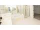 Bathroom featuring tile floors, large tub, shower and double sink vanity at 200 Ridge Bluff Ln, Suwanee, GA 30024