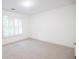 Bedroom features neutral carpet and paint, with plantation shutters on the window at 200 Ridge Bluff Ln, Suwanee, GA 30024