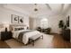 Spacious main bedroom with tray ceilings, ensuite, hardwood floors, and natural light at 200 Ridge Bluff Ln, Suwanee, GA 30024