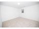 A bright bedroom features neutral carpet, white walls, and a window at 200 Ridge Bluff Ln, Suwanee, GA 30024