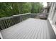 Back deck with gray railings and a view of the treelined backyard at 200 Ridge Bluff Ln, Suwanee, GA 30024
