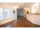 Bright dining area featuring hardwood floors, a large window, and a view to the kitchen at 200 Ridge Bluff Ln, Suwanee, GA 30024