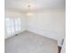 Empty dining room with a modern chandelier and carpet at 200 Ridge Bluff Ln, Suwanee, GA 30024