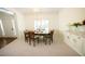 Elegant dining room with seating for six, decorative wall trim, and carpet at 200 Ridge Bluff Ln, Suwanee, GA 30024