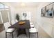 Bright dining room with a dark wood table and modern white chairs at 200 Ridge Bluff Ln, Suwanee, GA 30024