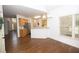 Dining room with wood floors, large window, and open access to kitchen with breakfast bar at 200 Ridge Bluff Ln, Suwanee, GA 30024